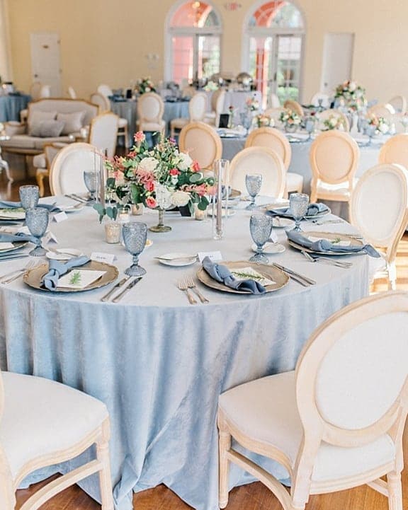 reception with light blue tablecloths and accents with white chairs by Puff 'n Stuff Catering