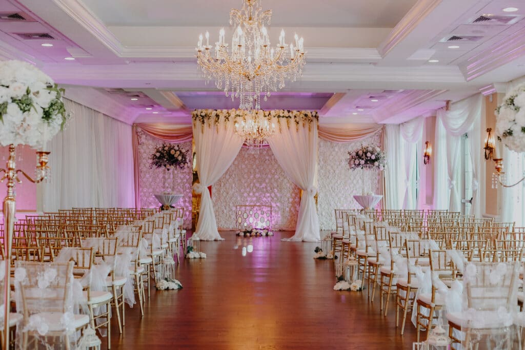 photo by Carolina Irais Photography of reception room in pink and white with gold accents and chairs