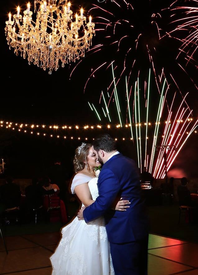 bride and groom dance under chandelier with fireworks by Imperial Pyro and Special Effects LLC going off