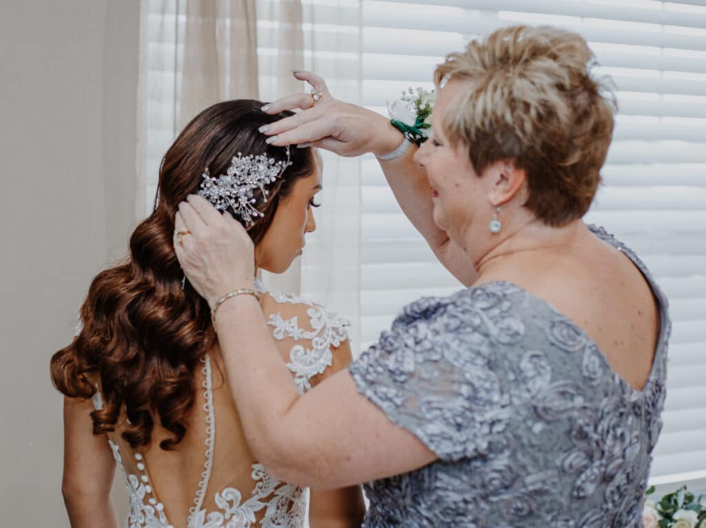 mother of the bride putting an elegant adornment in brides hair photo by Carolina Irais Photography