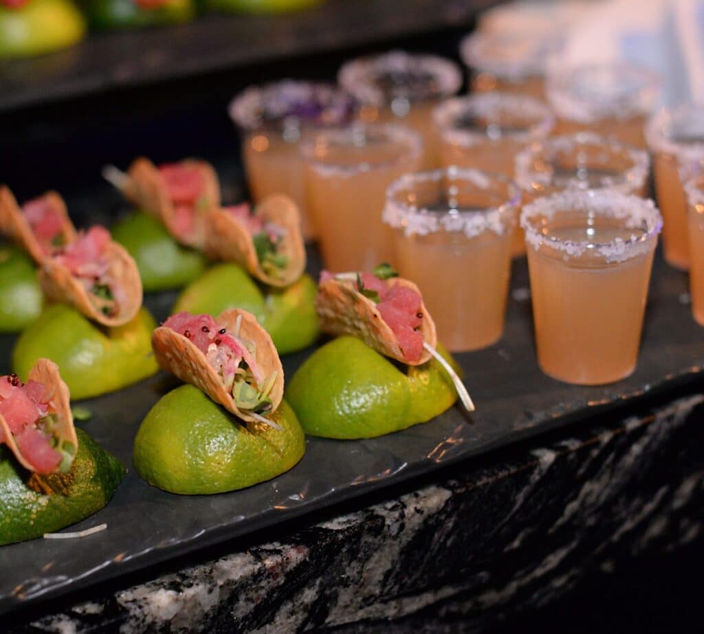 mini margaritas and shrimp tacos on limes by Puff 'n Stuff Catering