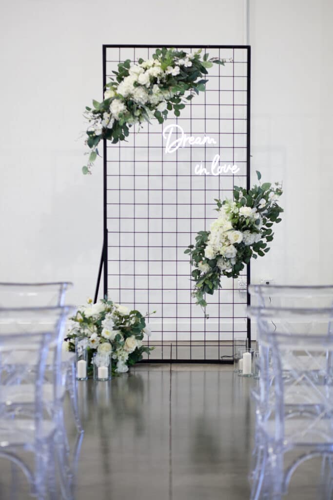 silver grid backdrop with wedding flowers at D'Space Orlando