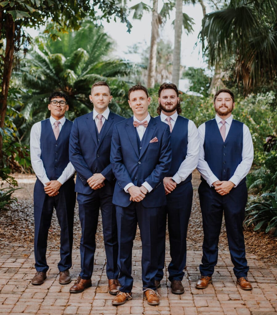 Groom and groomsmen in blue suits with brown showes and lavendar accents photo by Carolina Irais Photography