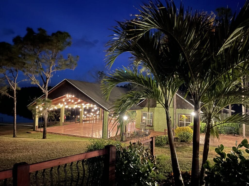 casani estates lakefront outdoor wedding venue with palm trees at night
