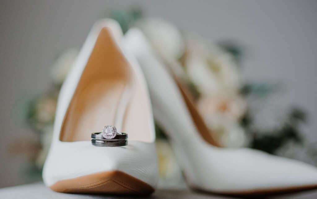 bridal pumps with wedding rings adorning them photo by Carolina Irais Photography