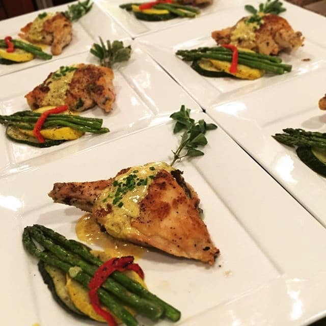 chicken and wrapped asparagus presented by Cuisiniers Catered Cuisine and Events