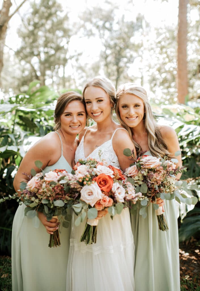 bride with bridesmaids in seafoam green by Joanna Moore Photography