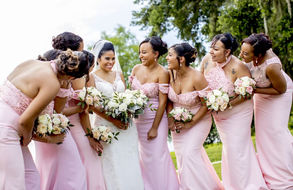 bride with bridesmaids in pink photographed by Sterling Photography International