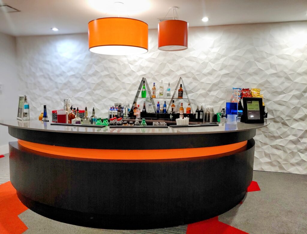 orange accents in modern bar setup at Avanti International Resort
