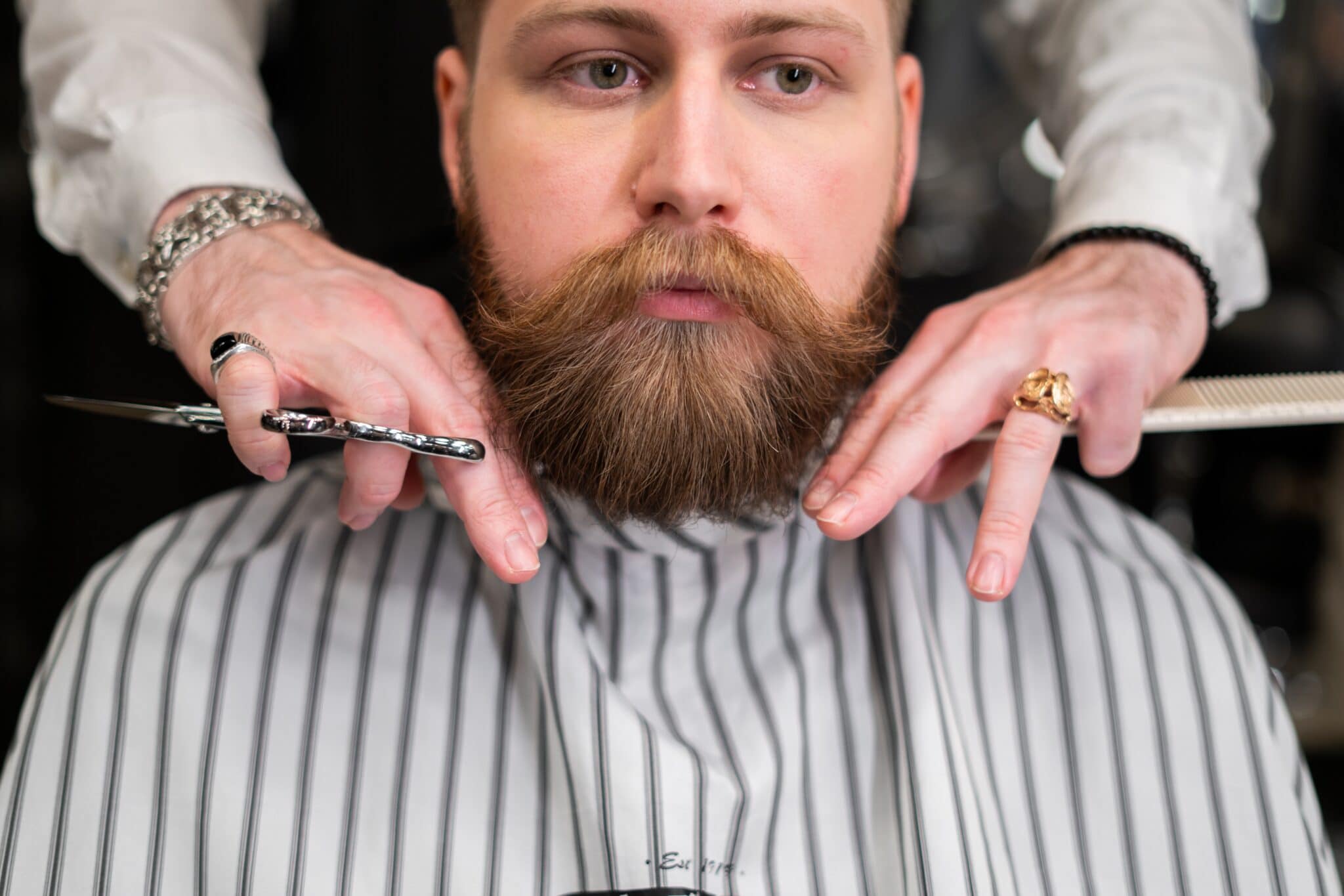 Gentleman getting his beard trimmed and groomed