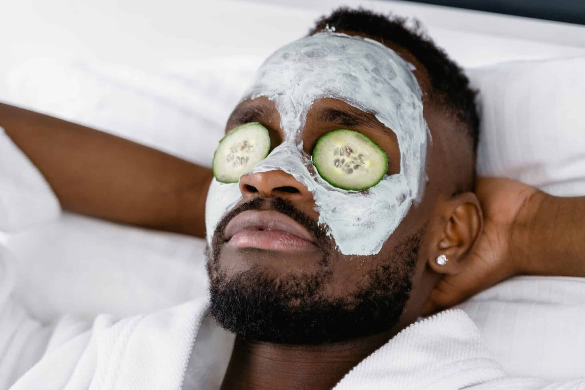 man getting facial with cucumber eye relief for Essential Pre-Wedding Grooming Treatments