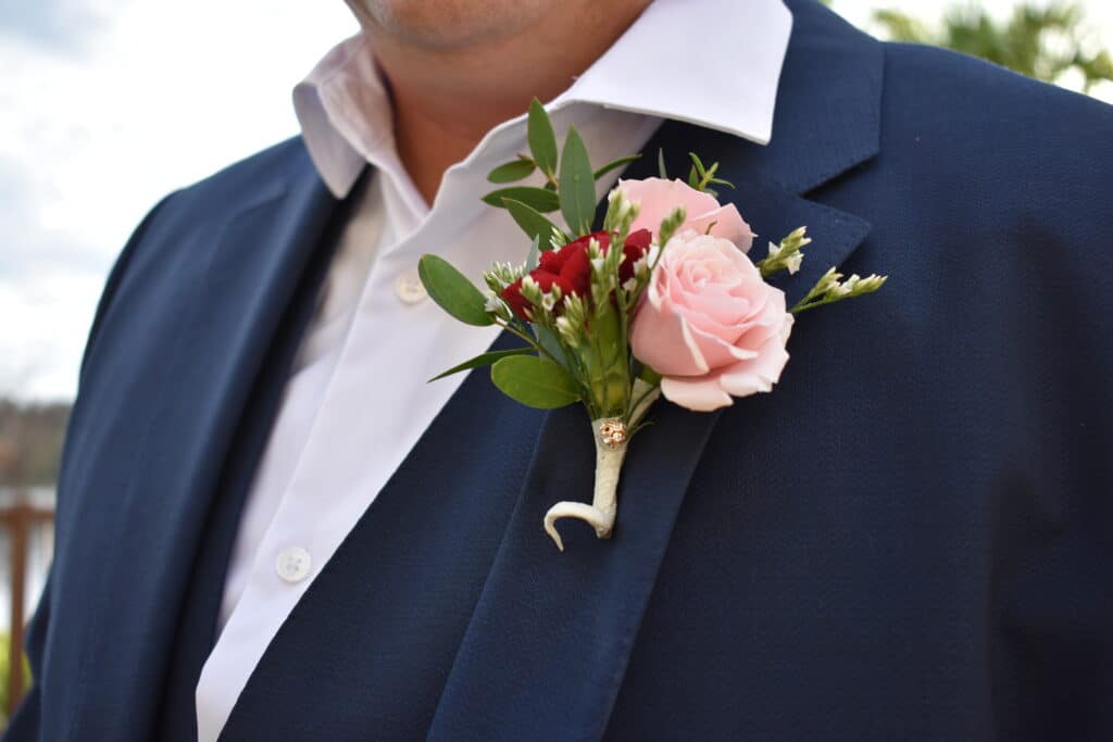 grooms boutonniere of pink and red roses by Stems in Bloom
