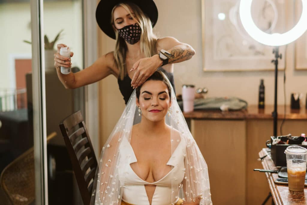 bride having hair and veil done by hairstylist photo by Rudy and Marta Photography