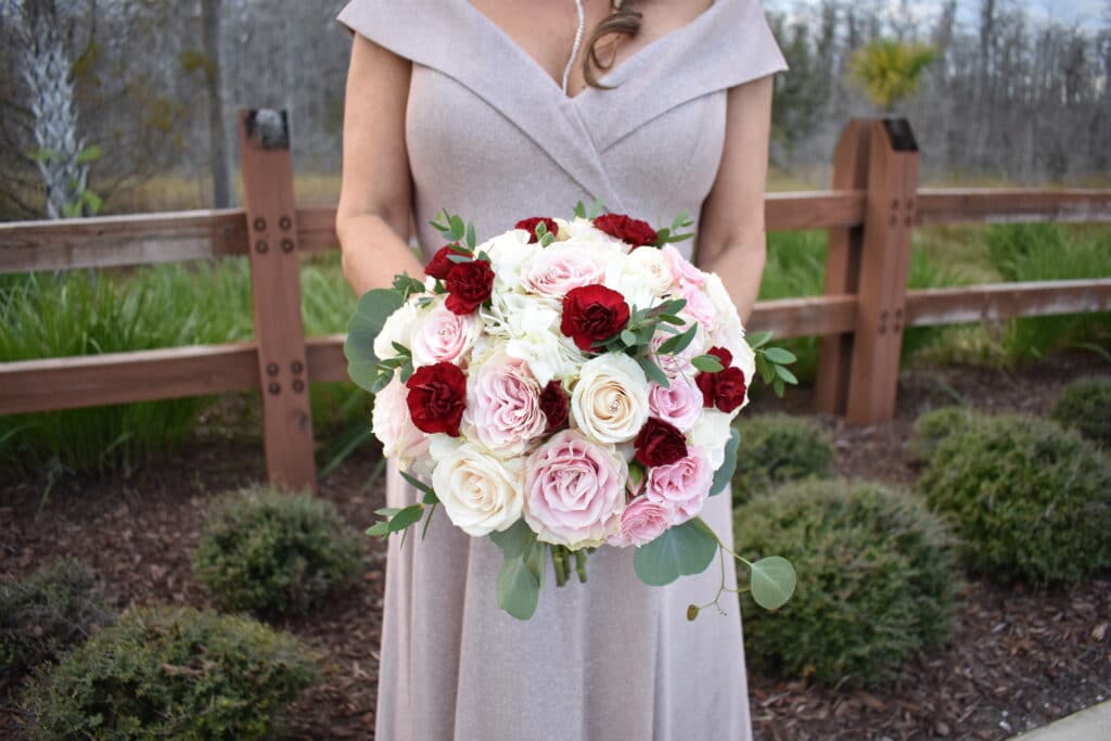 brides rose bouquet of red, pink and white roses by Stems in Bloom