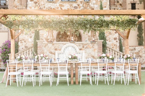 Bridal table set up in front of a chic stone and brick building