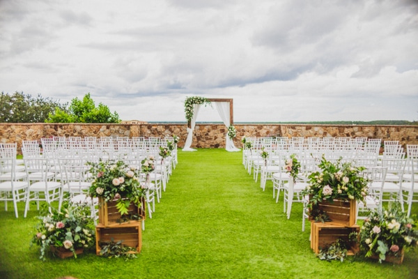 Rustic ceremony set up with a wooden arch at the front