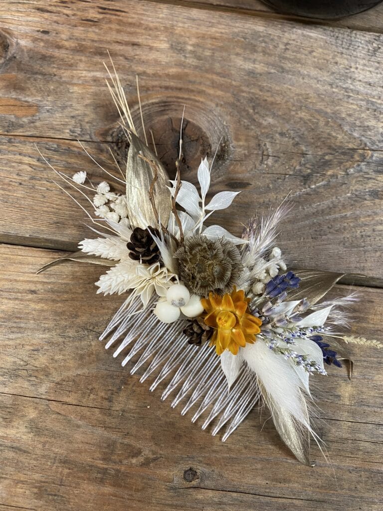 hair piece of white and orange flowers by Stems in Bloom
