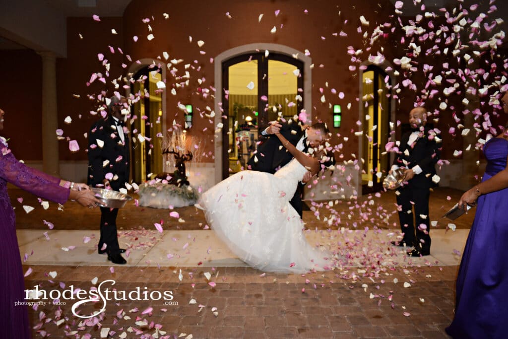 groom dipping bride under a cloud of confetti by Bold Beautiful and Beyond weddings