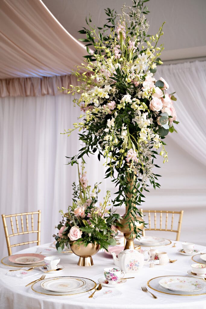 tall table centerpiece at wedding reception by Stems in Bloom