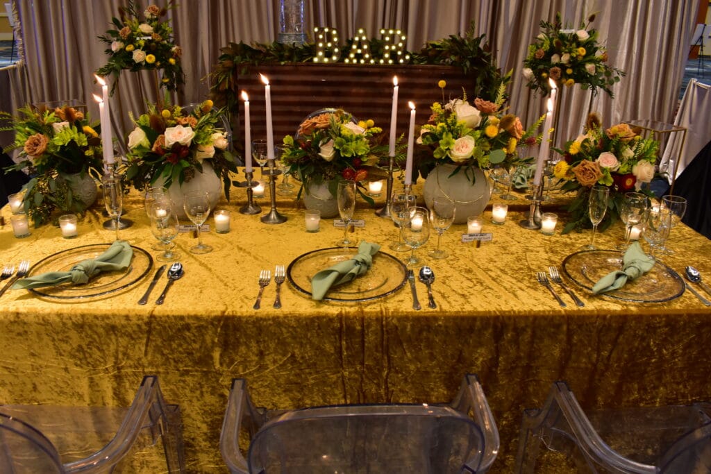 gold tablecloth with autumn flowers and candles by Stems in Bloom