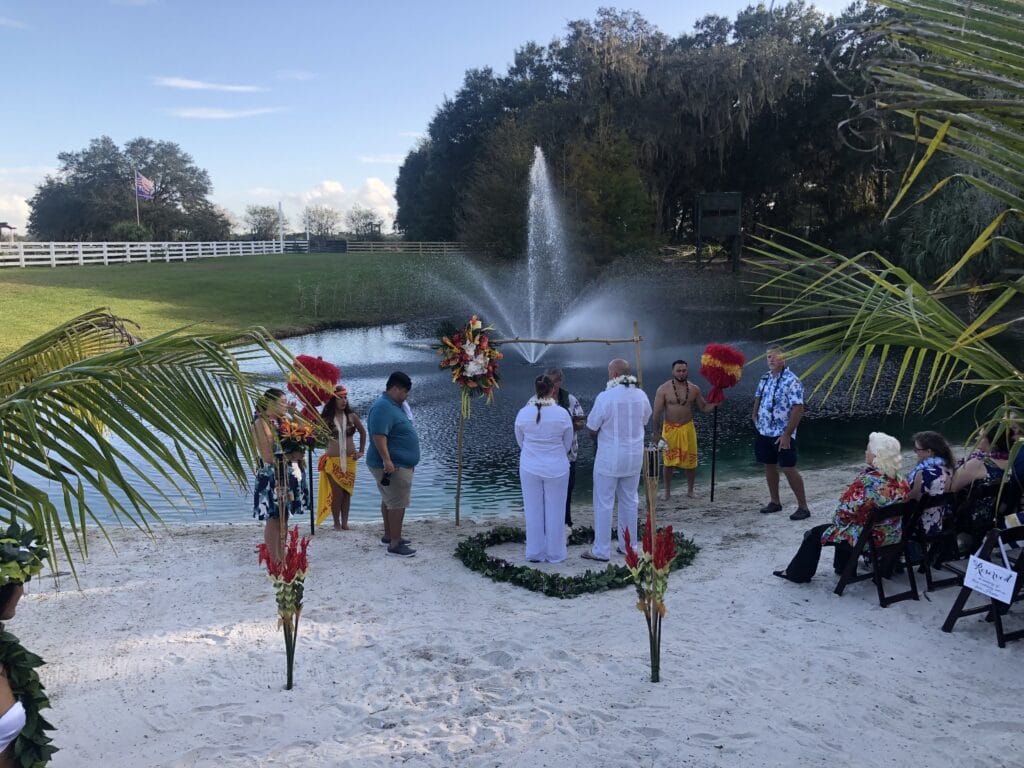 Couple getting married in front of a fountain.