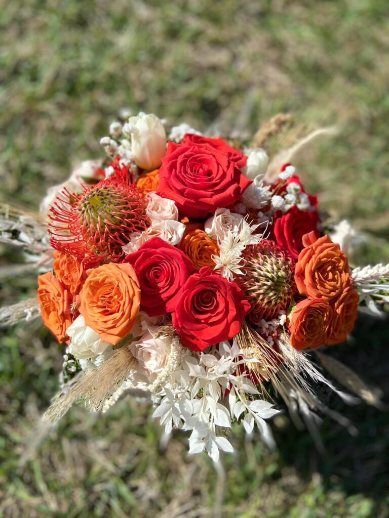 brides ombre bouquet in reds and orange roses by Stems in Bloom