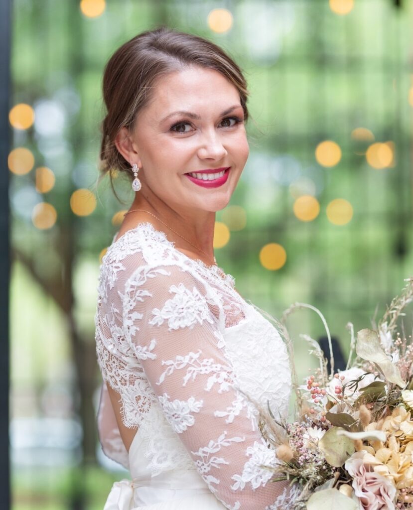 smiling bride with bright red lip with hair and make-up by Awe Glammed Up