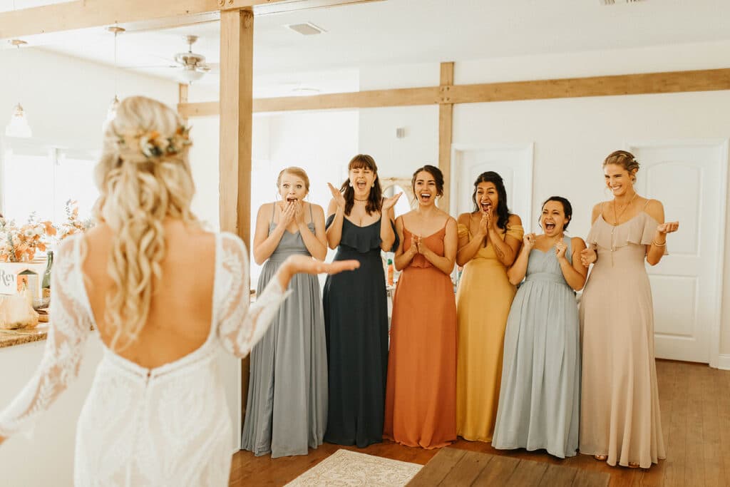 bride showing bridesmaids in various colored dresses at Bramble Tree Estate