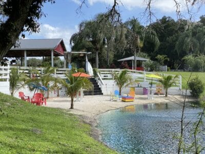 Lake area with a pavilion. There are beach chairs and umbrellas