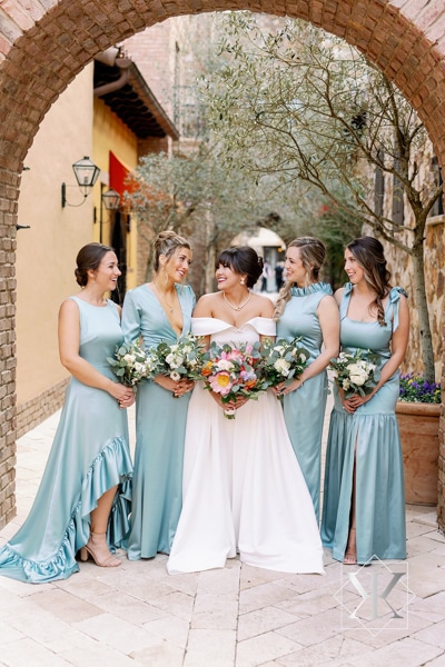 Bride surrounded by her bridesmaids in light blue dresses