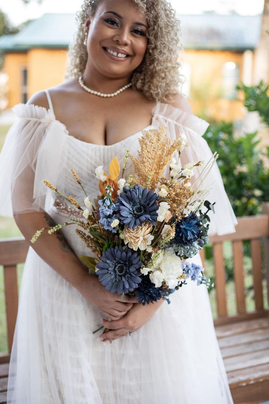 bride holding bouquet from blue winter boho wedding at Camp Ithiel
