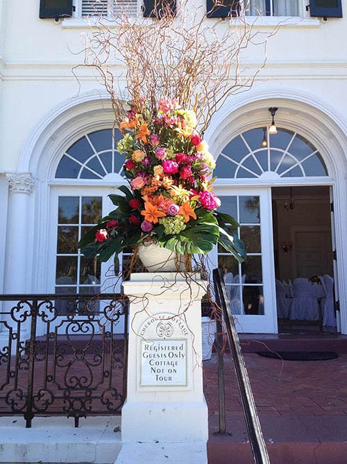 outdoor flower display on white pillar by Leaf & Blossom Co.