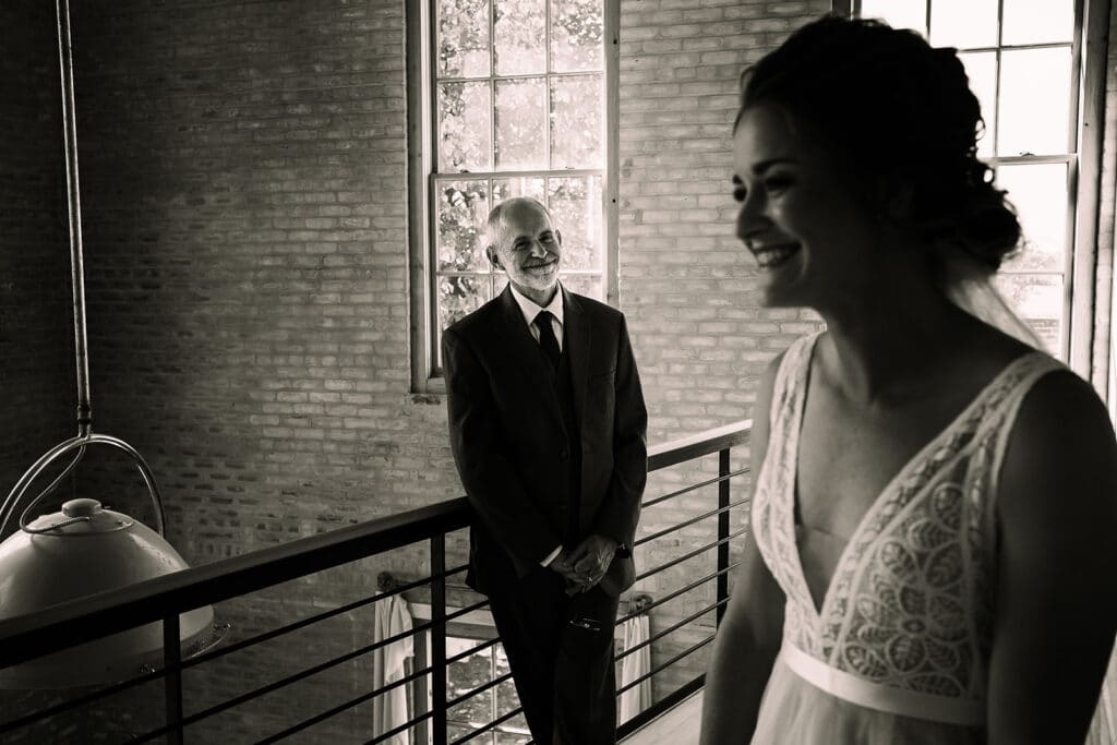 bride smiles as father of bride looks on with pride by Roy Serafin Photo Company