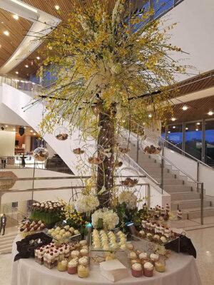 tall and wispy floral centerpieces at a dessert table by Leaf & Blossom Co