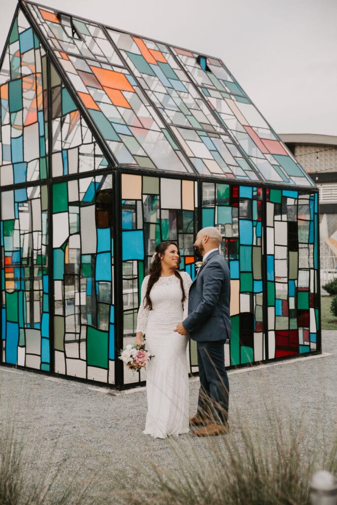 couple in front of stained glass house at Dockside Lake Nona