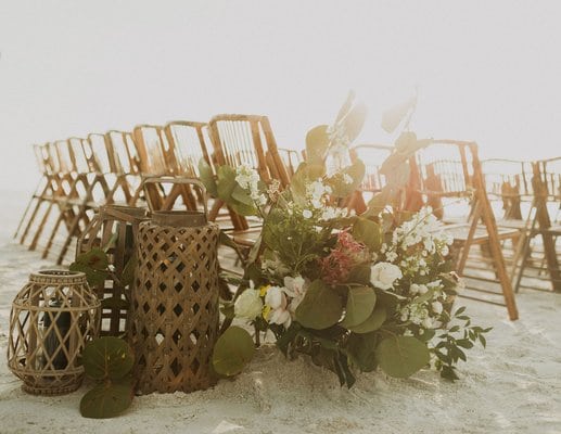 beach setting with sea grape and hydrangeas with wicker baskets and rattan chairs by A Chair Affair Inc.