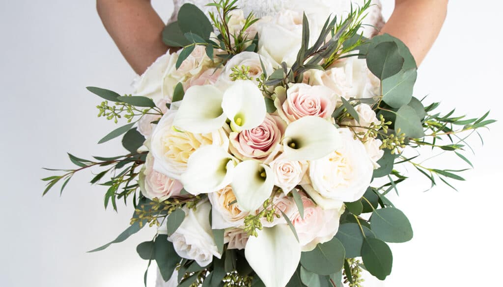 bridal bouquet of white roses and lilies by Leaf & Blossom Co.