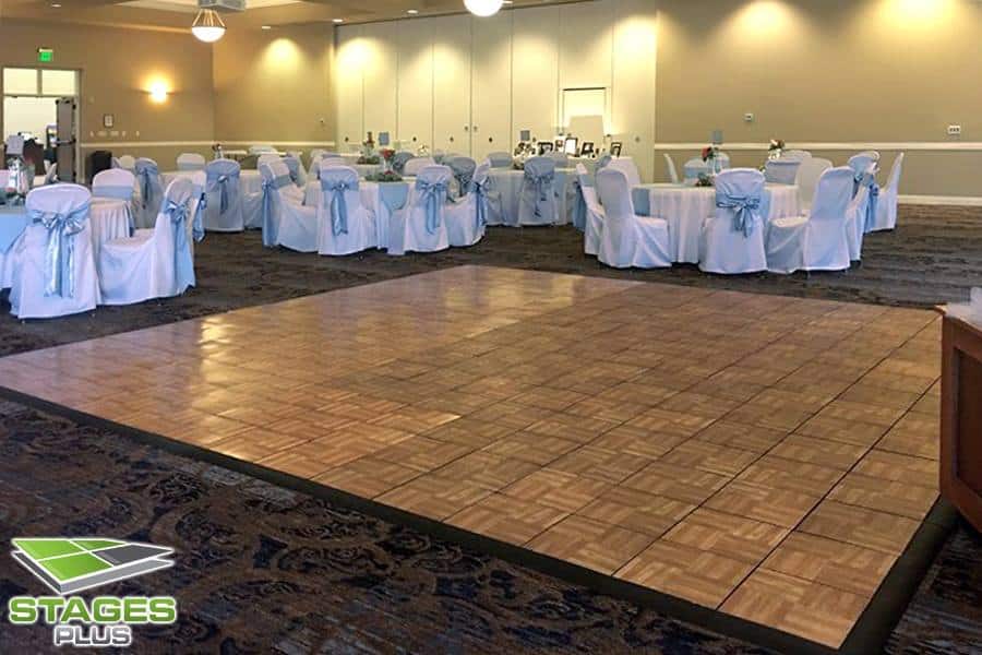wooden dance floor from Stages Plus in Central Florida set up at wedding reception