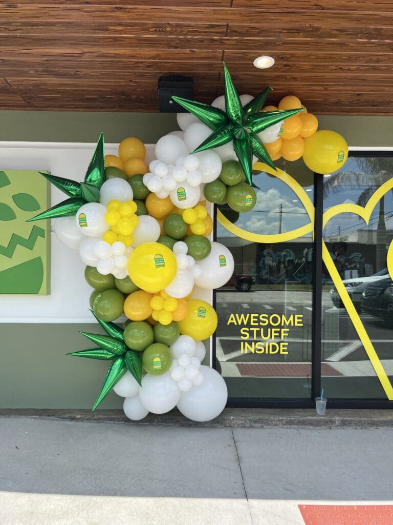 yellow and white balloon arch with tropical balloons makes welcoming sign by Fab and Float events
