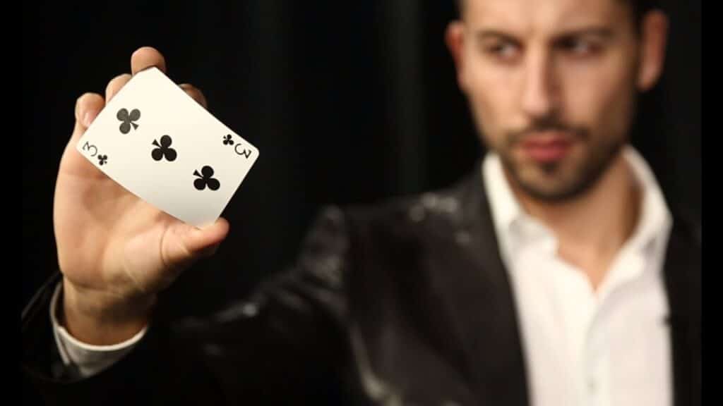 magician showing a 3 of clubs from Dawn Gilmore Productions