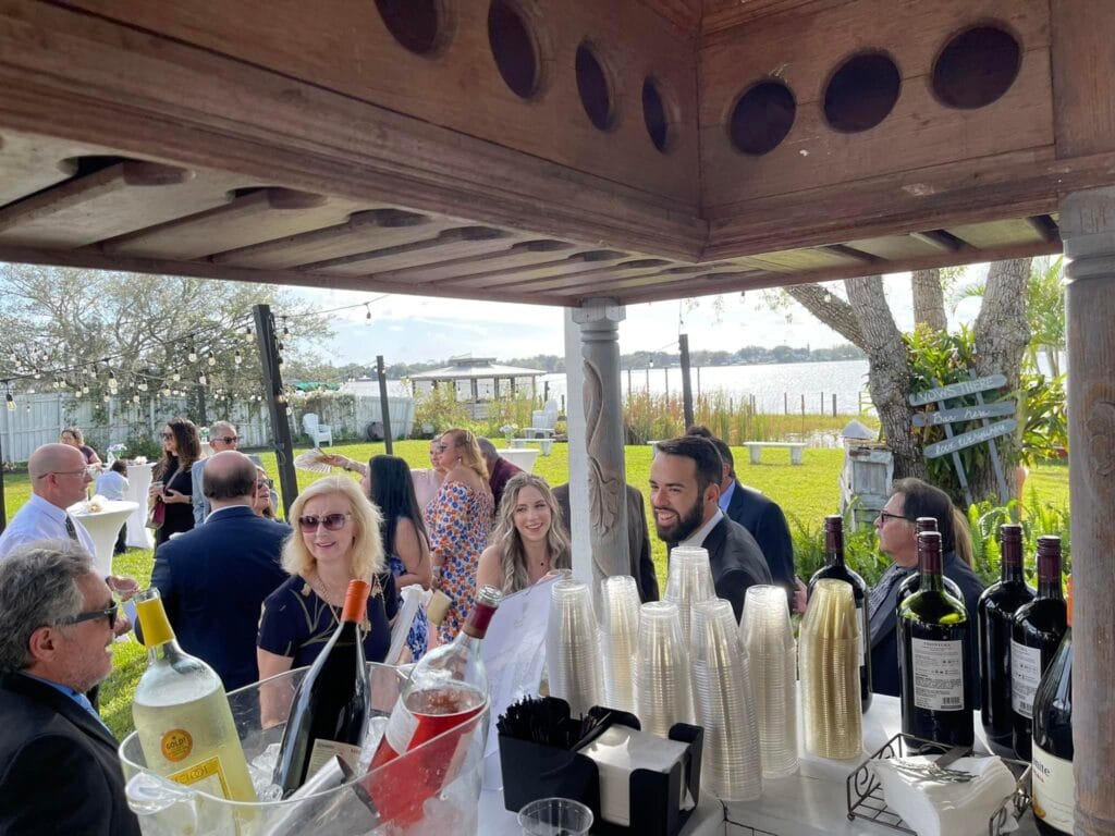 wedding party outdoors by a lake with a wine bar and bartender from Cool Breeze Bartending