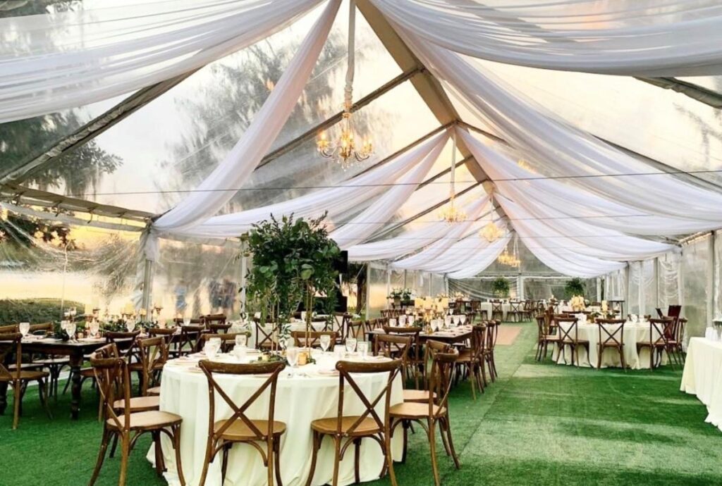 large tented room with grass carpet from Dawn Gilmore Productions