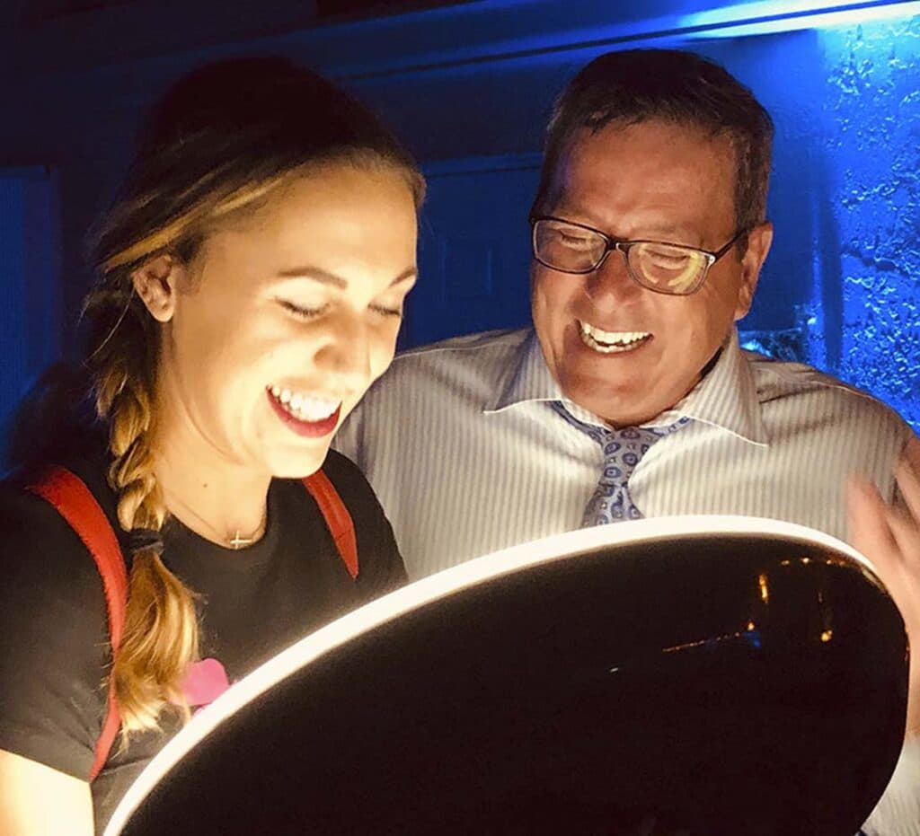 man and woman looking at images with special lighting and smiling