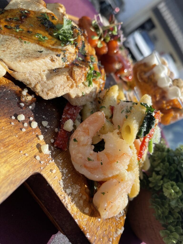shrimp and bread on a wooden platter by Corwin's Personal Chef and Catering Services