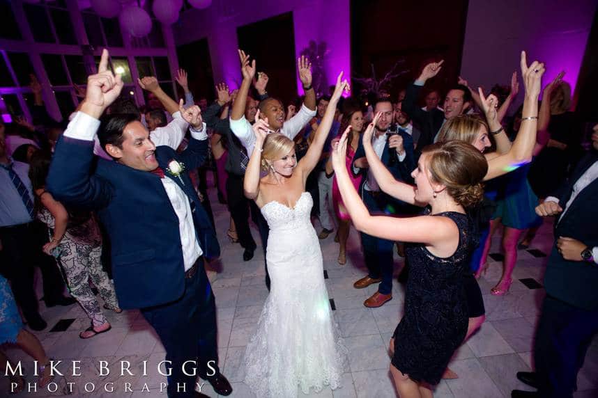 bride and groom dancing with their wedding guests at reception