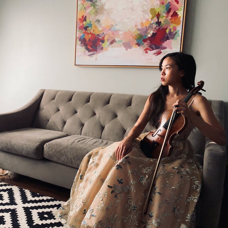 violinist from Dawn Gilmore Productions in a floral dress waiting to perform