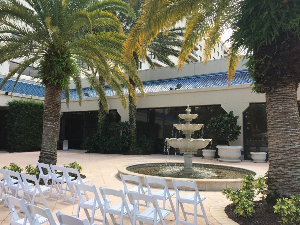 Renaissance Orlando at Seaworld near a fountain with white chairs ready for a wedding ceremony