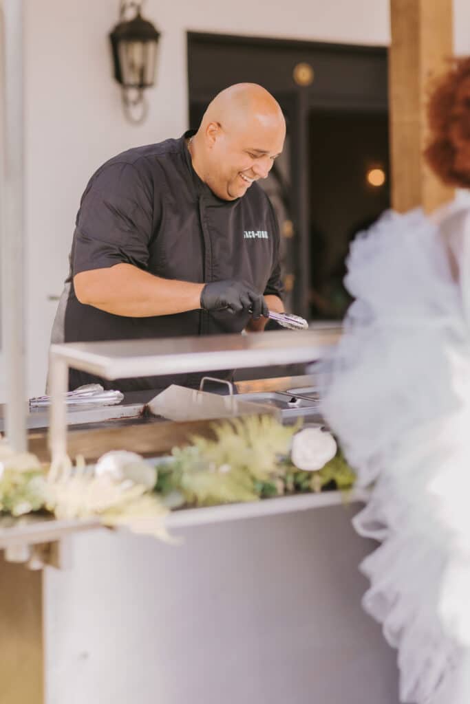 serving tacos to a bride at the wedding reception by the Taco Kings