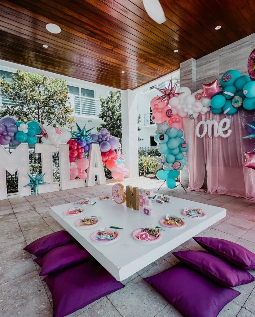 pink, turquoise and purple accent room with floor cushions and colorful walls filled with balloons by Fab and Float events