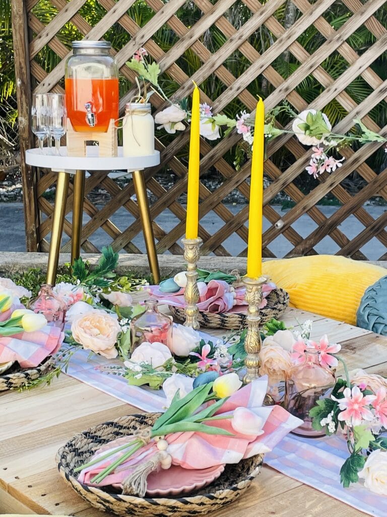 Pastel wedding decor on a table. There are tulips and a drink station for guests.